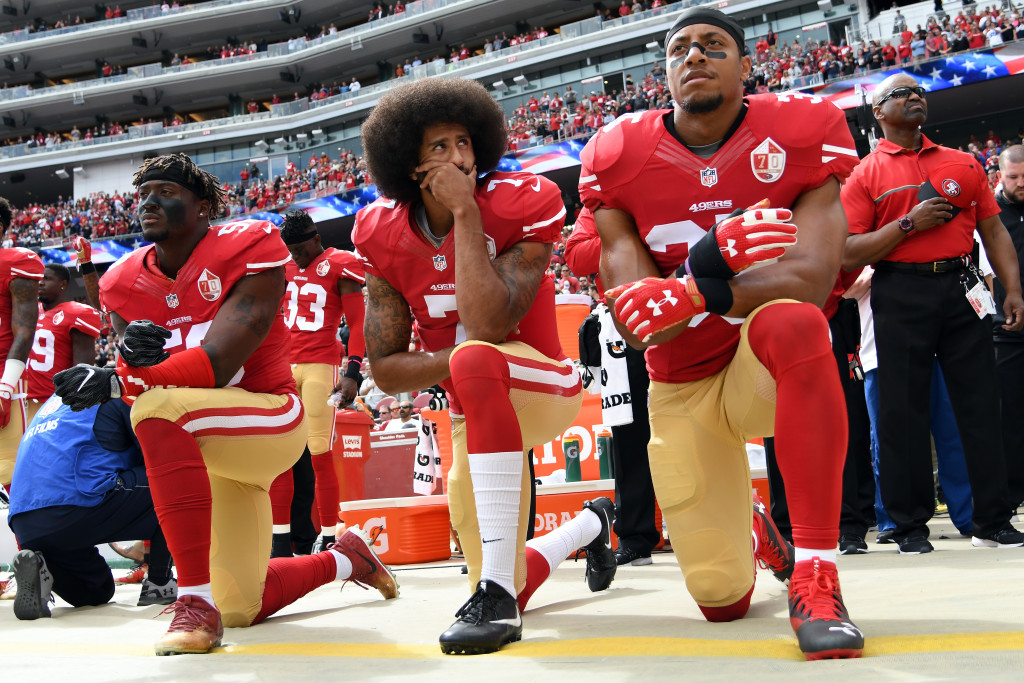 SANTA CLARA, CA - OCTOBER 02: (L-R) Eli Harold #58, Colin Kaepernick #7 and Eric Reid #35 of the San Francisco 49ers kneel on the sideline during the anthem prior to the game against the Dallas Cowboys at Levi's Stadium on October 2, 2016 in Santa Clara, California. (Photo by Thearon W. Henderson/Getty Images)